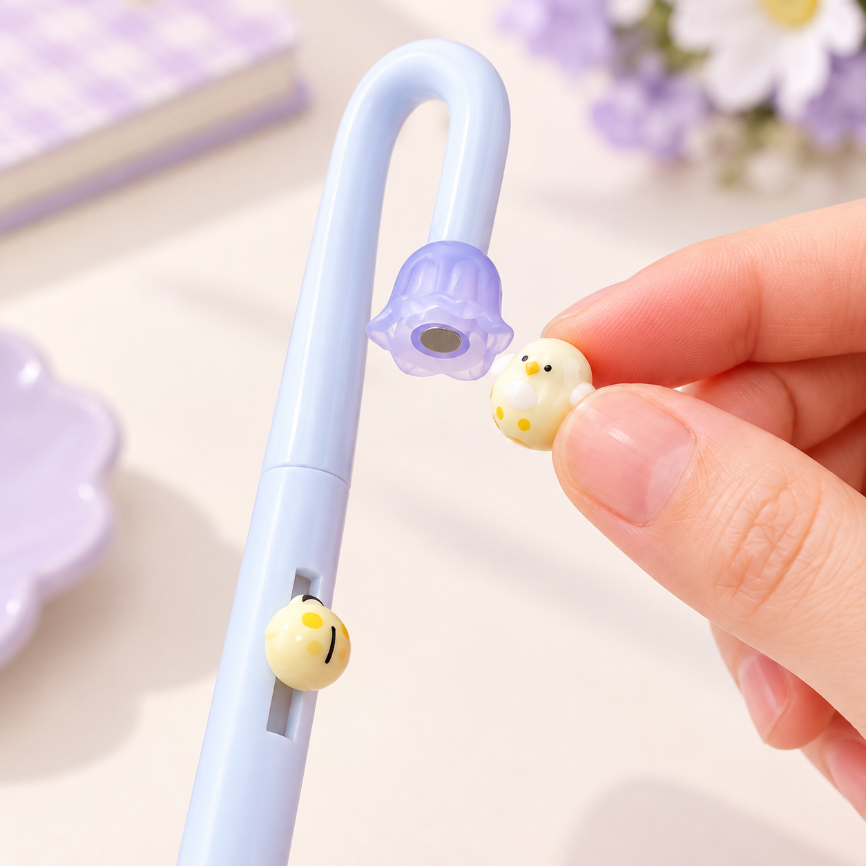 Detachable magnetic bird charm on a blue PerchPop Gel Pen