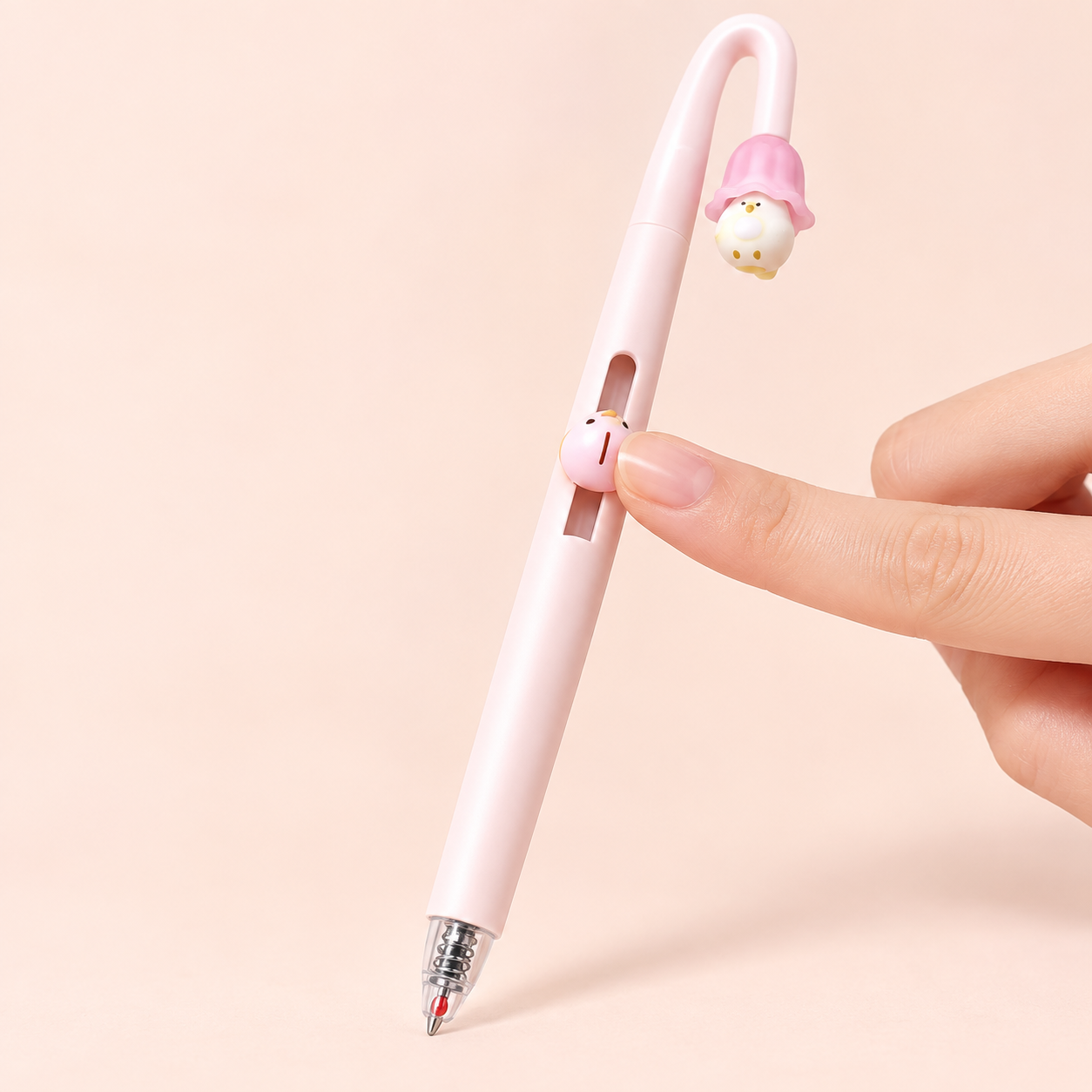 Bird-shaped slider extending the tip of a pink PerchPop Gel Pen