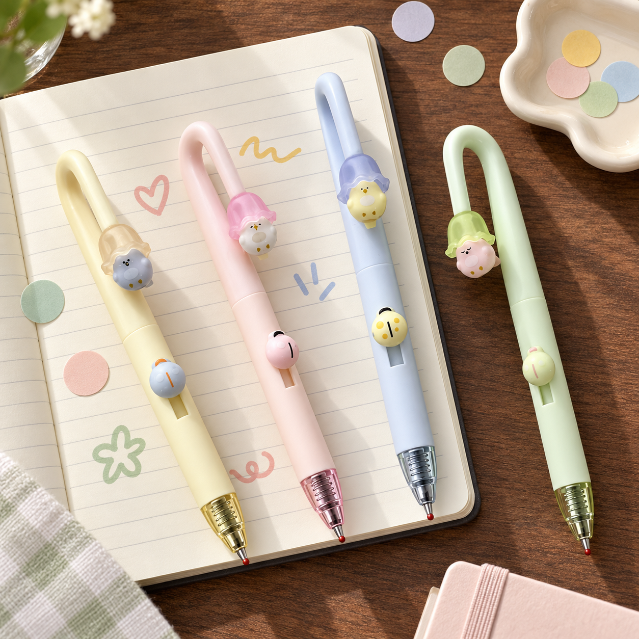 Four PerchPop Gel Pens arranged on a notebook