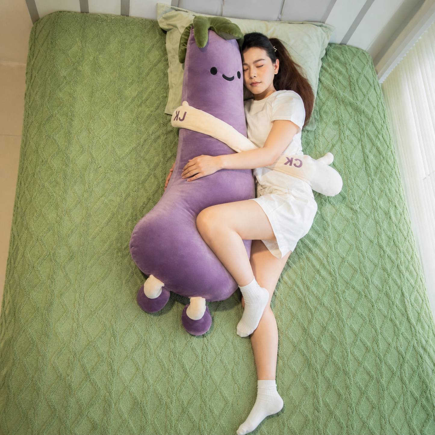 Full-body view of the Lucky Eggplant HugBeat cuddle plush